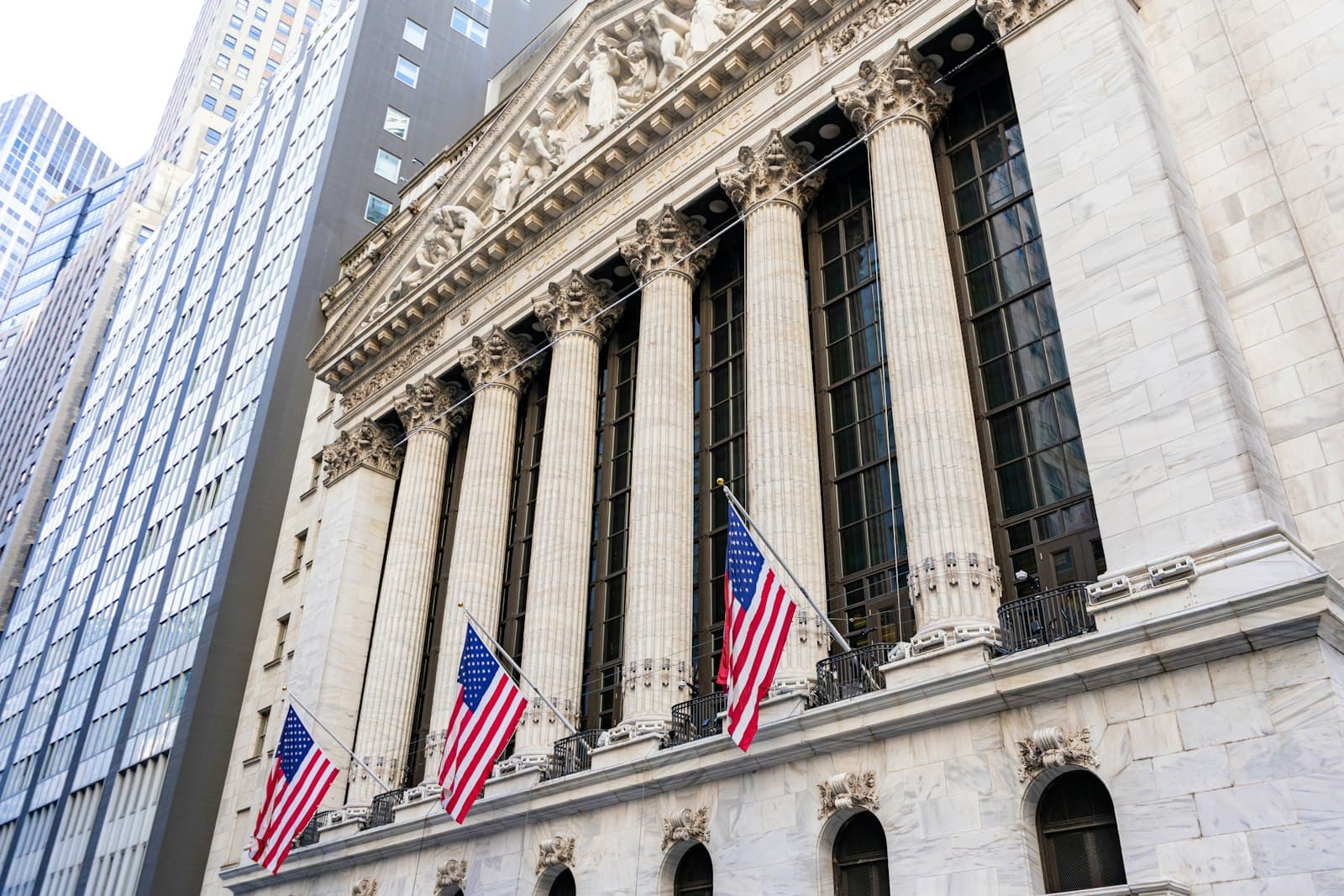 The New York Stock Exchange building facade with American flags