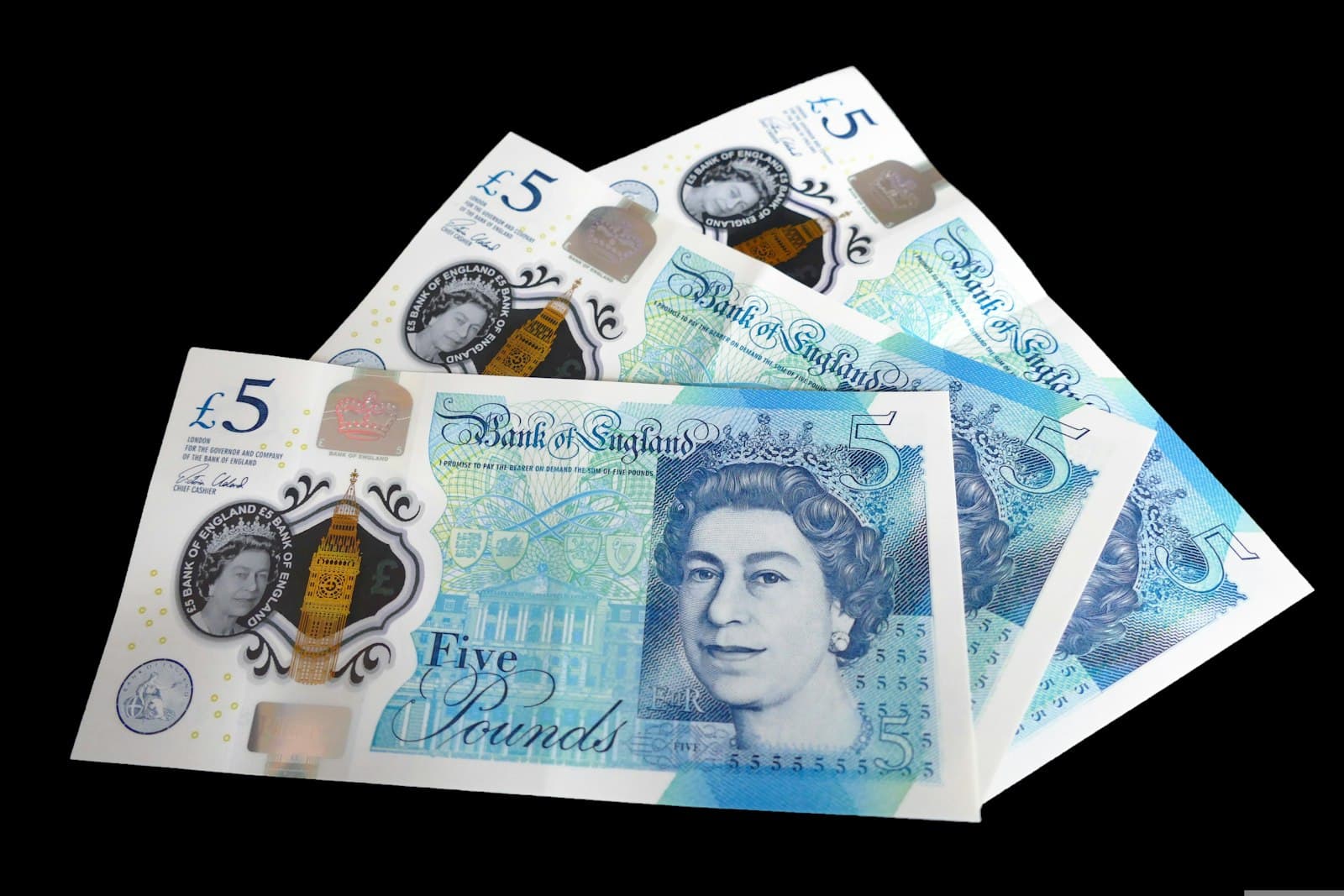 A pile of British pound sterling banknotes