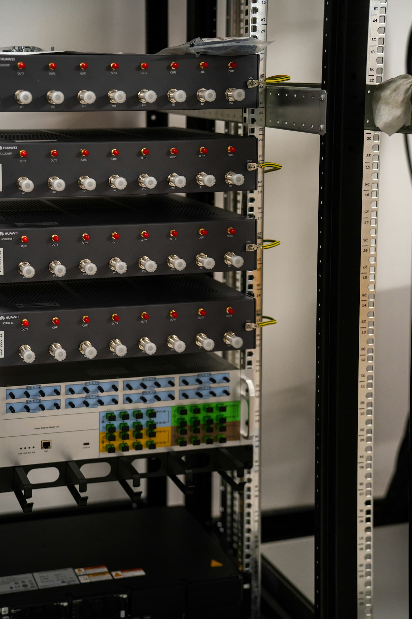 A rack of server hardware with glowing red indicator lights