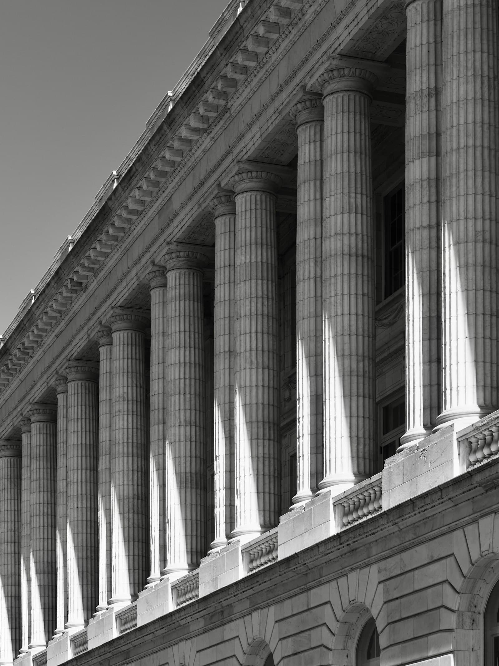 A dramatic black-and-white photo of classical courthouse columns